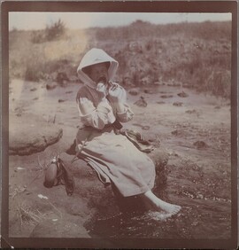 Mary Gallen-Kallela bathing her feet in the river.