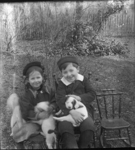 Boy and girl with puppies n.d.
