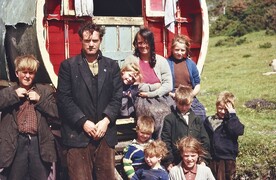 Irish Traveller family outside their caravan.