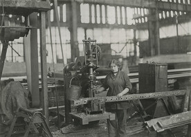 Woman operating vertical drilling machines, drilling angles for connections to ribs of airship sheds