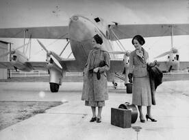 Models posing for a fashion shoot in front of a Qantas biplane 1936