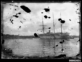 Three-masted ship and two dinghies.