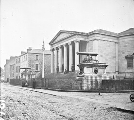 "Large public building, railings, steps, 6 columns in portico, 2 guns on plinths, one plinth inscribed India" is Tralee Courthouse
