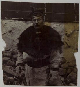 A man dressed in fur with a four winds hat on his head.