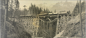 [View of train crossing trestle bridge]