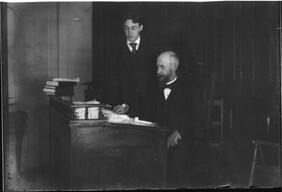 Man and boy at desk n.d.
