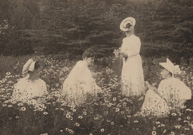 Four women in field of flowers, date unknown