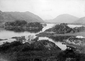 "Lake surrounded by mountains in an unknown location" (is lakes of Killarney)