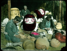 Men making clay moulds for giant masks.