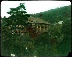 Large building (temple?) in wooded setting.