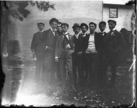 Group of young men in back of building n.d.