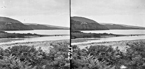 Tidal waters and tree-covered hills.