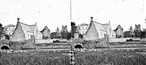 "River, single arch bridge in foreground, small modern church, adjoining church ruin, modern square tower background" is Cong
