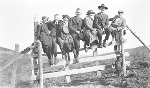 Group posing on fence