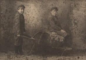 Portrait of two boys with wheelbarrow, date unknown