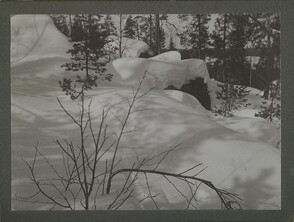 Snow-covered boulders on top of a cliff