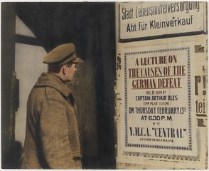 Soldier looking at billboard: â€œLecture on causes of German defeat.."