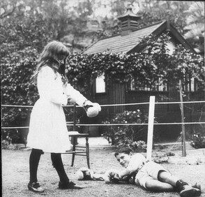 Banjo Paterson's children Grace and Hugh boxing with Christmas present gloves, Sydney, NSW, 1919 / photographer unknown