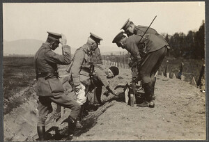 Colonel Sam Hughes and officers examining MacAdam Shovel used as a target