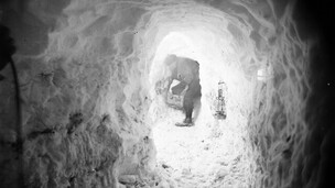 Xavier Mertz Bringing in a box of Ice through the Catacombs, Antarctica,  1912, by Frank Hurley